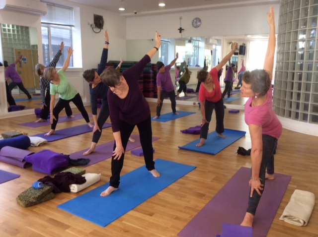 Yoga Instructor teaching Triangle Pose at one of our Yoga Classes Crouch End.